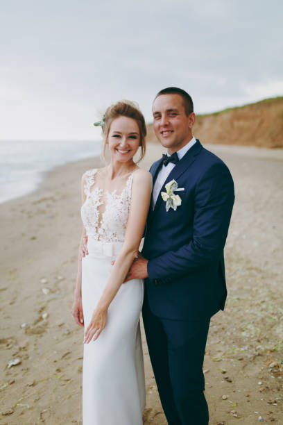 istock Groom and bride on a walk outdoors at the sea 856024560