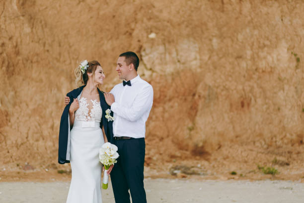 istock Groom and bride on a walk outdoors at the sea 856027664
