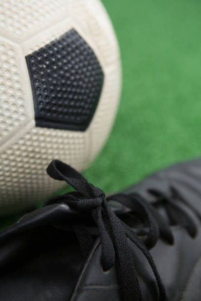 istock Football and cleats on artificial grass 856027718