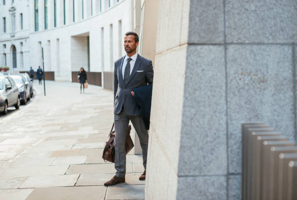 istock Mature businessman leaving five star hotel with suitcase 856028112
