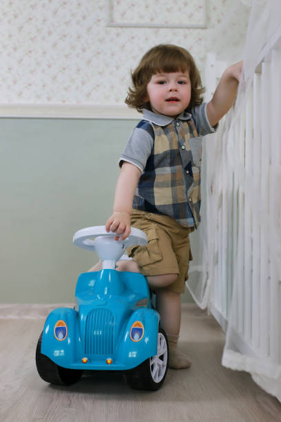 istock litle boy sit on a toy car 856030788