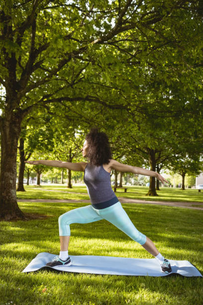 istock Woman performing stretching exercise in the park 856038450
