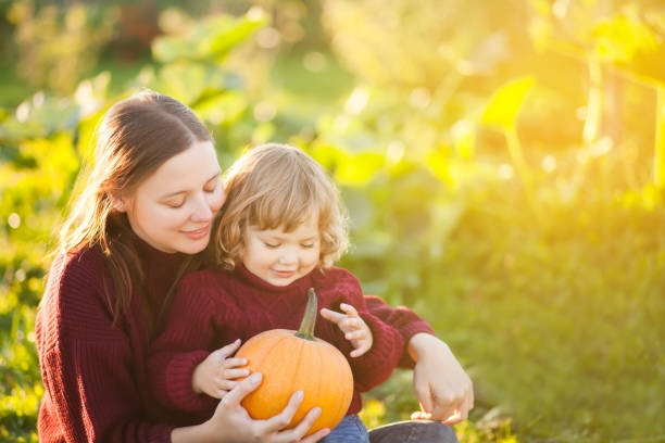 istock Mother and child with pumpkin harvest 856038976