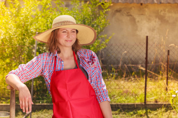 istock woman standing with shovel in garden 856045982