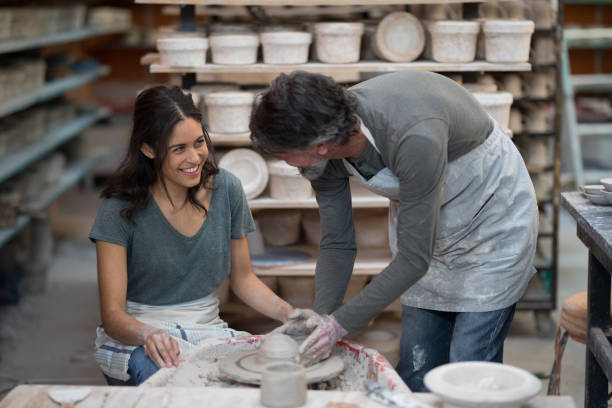 istock Male potter assisting female potter 856048836