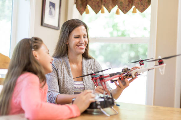 istock Mom and daughter examining a drone at the kitchen table 856049298
