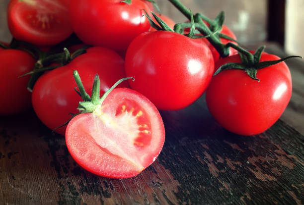 istock tomatoes on wooden background 856049424