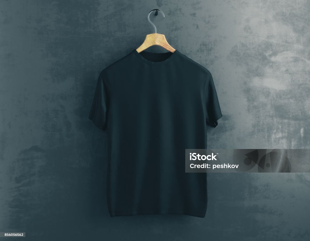 Clothes concept Wooden hanger with empty black t-shirt hanging on dark concrete background. Clothes concept. Mock up. 3D Rendering T-Shirt Stock Photo