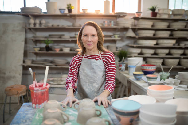 istock Portrait of female potter standing at worktop 856056740