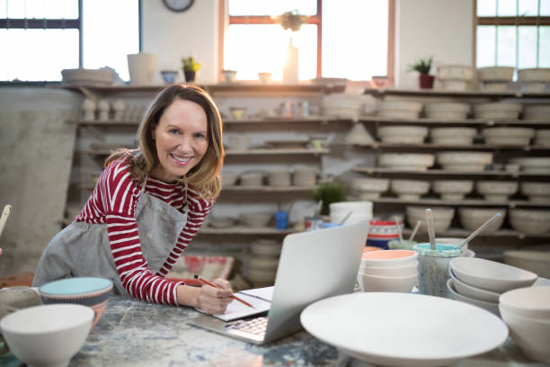 istock Female potter checking the orders from laptop 856056914