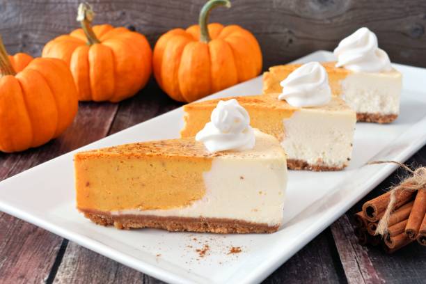 istock Three slices of pumpkin cheesecake on white serving plate 856060730