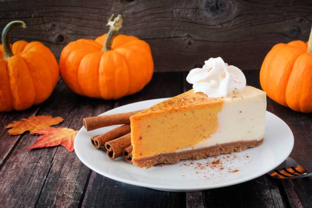 Slice of pumpkin cheesecake on dark rustic wood