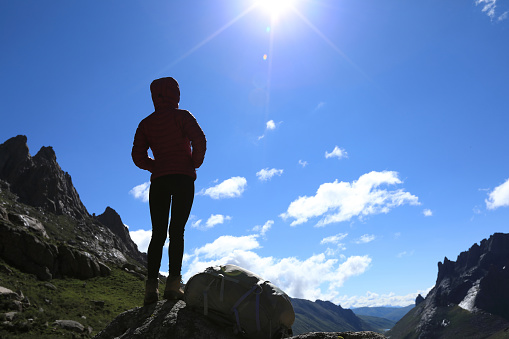 silhouette of woman hiking in mountains