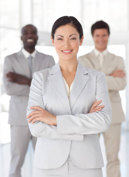 istock Charming businesswoman standing at the camera with arms folded 856076356
