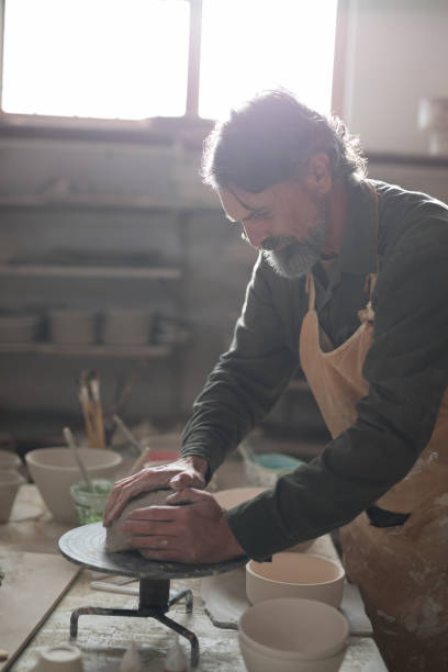 istock Male potter molding a clay 856083182