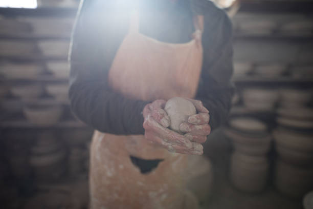 istock Mid section of male potter molding a clay 856083982