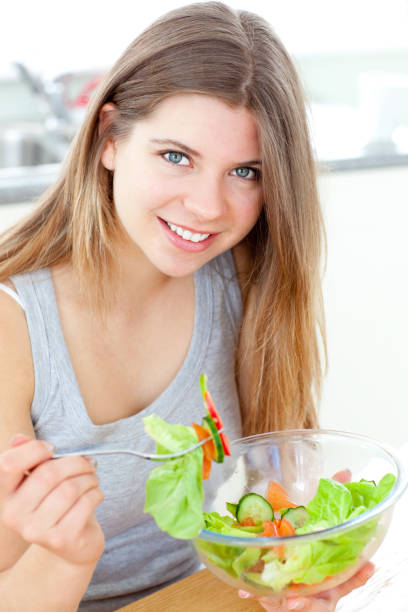 istock Handsome woman eating a salat 856084186