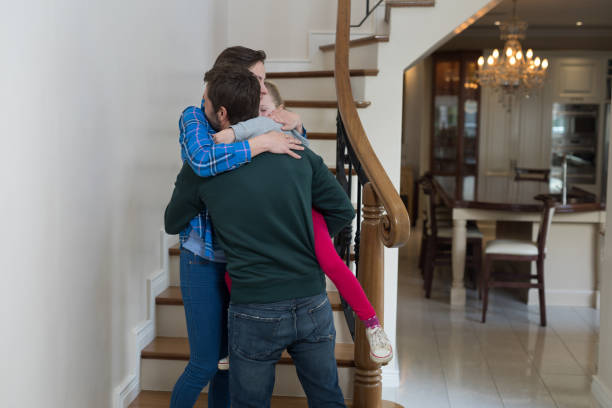 istock Parents and daughter hugging each other 856090346