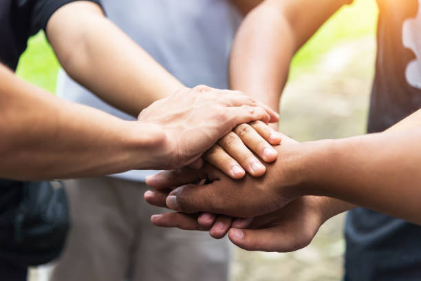 istock Teamwork concept,Business team standing hands together in the loft office.people joining for cooperation success business,win in every thing,vintage color 856091136