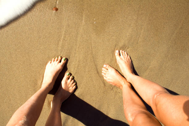 istock Female legs on the beach. 856093622