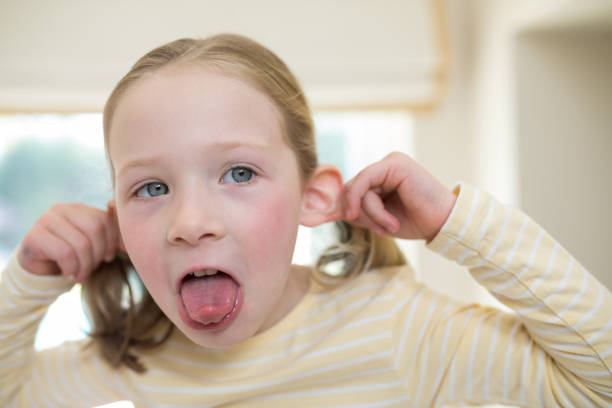 istock Young girl making funny faces 856093794