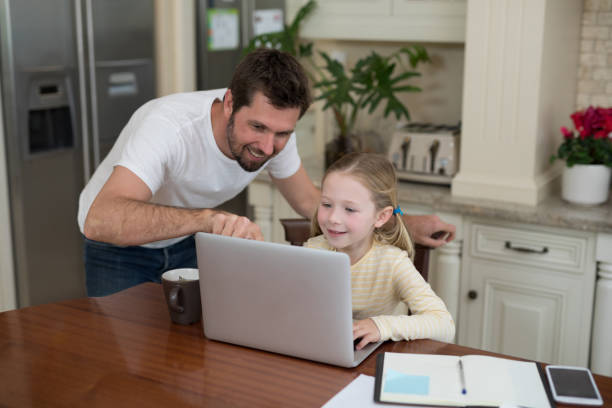 istock Father and daughter working on laptop 856093828