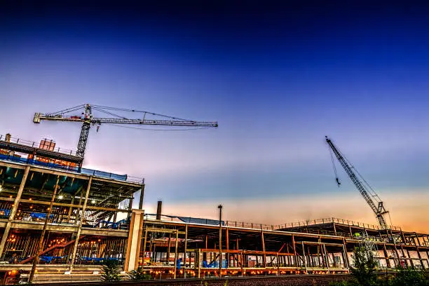 Photo of Cranes over building at dusk