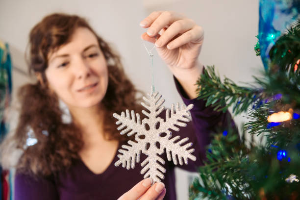 istock Atlanta Woman in 30s Decorating Christmas Tree 856094964