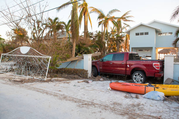 truck floated blocking entrance to house, replacing gate that was ripped off by a hurricane in ramrod key, florida - cyclone fence imagens e fotografias de stock