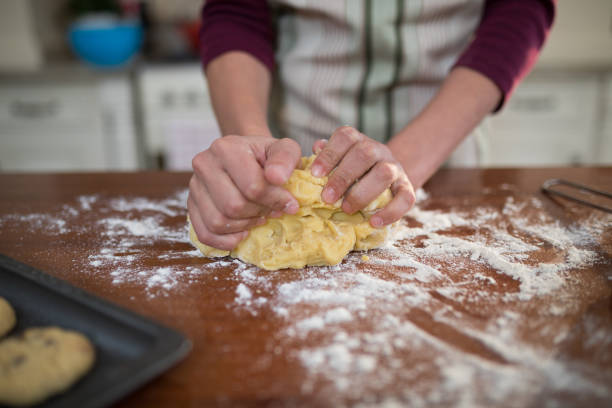istock Woman kneading dough in kitchen 856097406