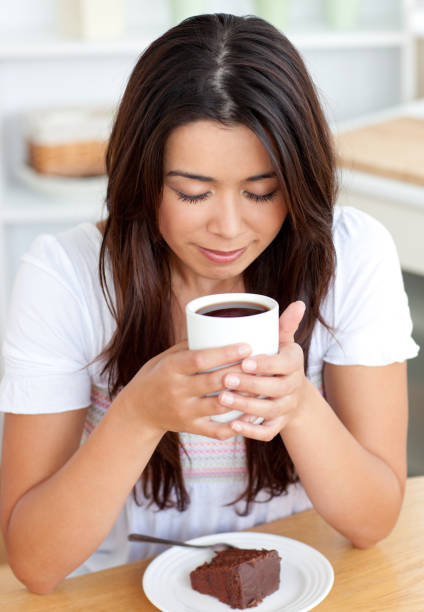 istock Twee woman sitting on sofa and drinking 856097932