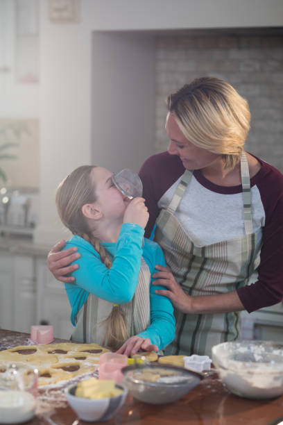 istock Mother and daughter having fun while preparing cookies in kitchen 856100912