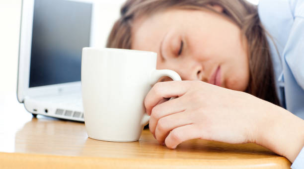 istock Slumbery woman sleeping on table in office 856101042