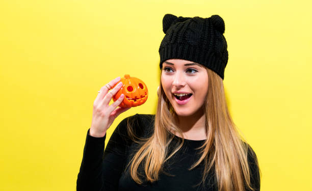 istock Girl wearing holding a Halloween pumpkin 856101620