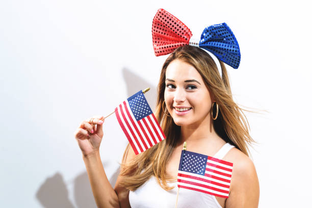 istock Happy young woman holding American flags 856101630