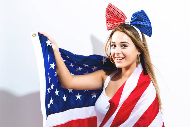istock Happy young woman holding American flag 856101648