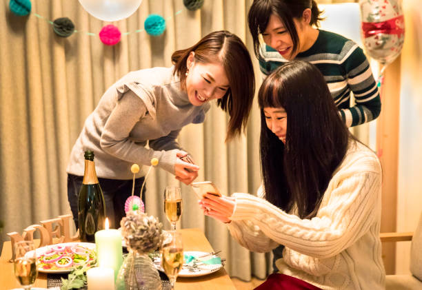 istock apanese girls enjoying a Christmas dinner party 856102140
