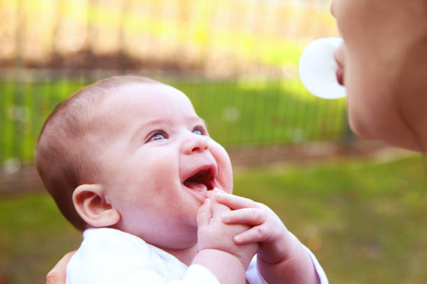 Mother and baby blowing chewing gum bubbles