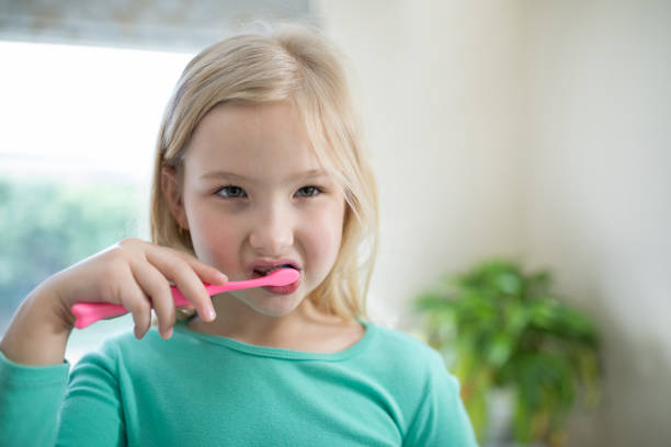 istock Girl brushing teeth in the bathroom 856105380