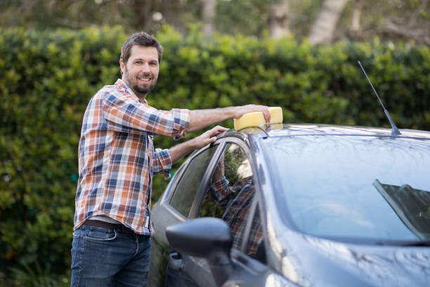 istock Man washing a car on a sunny day 856108248