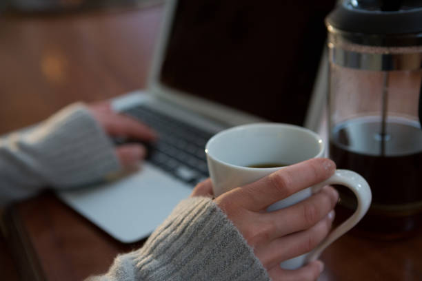 istock Mid-section of woman using laptop 856109518