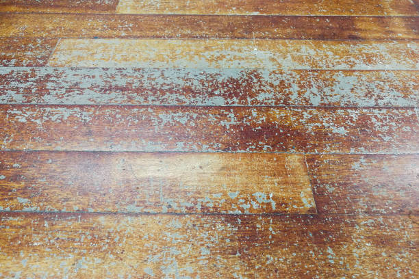 istock Damaged seasoned wooden floor plank with scratch marks needs restoration 856109570