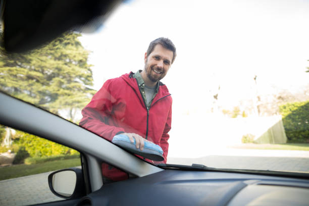 istock Man washing a car on a sunny day 856116186