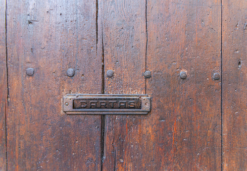 Old letterbox in the door, traditional way of delivering letters to the house, old mailbox, correspondence