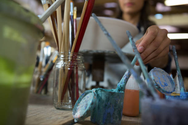 istock Female potter painting a bowl 856122458