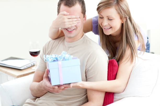 istock Smiling woman giving a present to her boyfriend 856122996