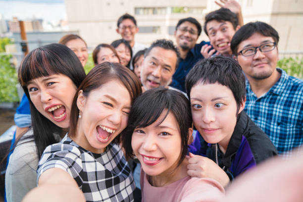 istock Group of friends at a rooftop party taking a selfie 856126674