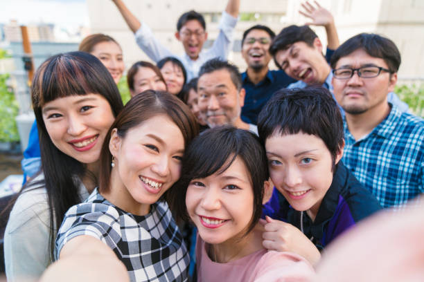 istock Group of friends at a rooftop party taking a selfie 856126678