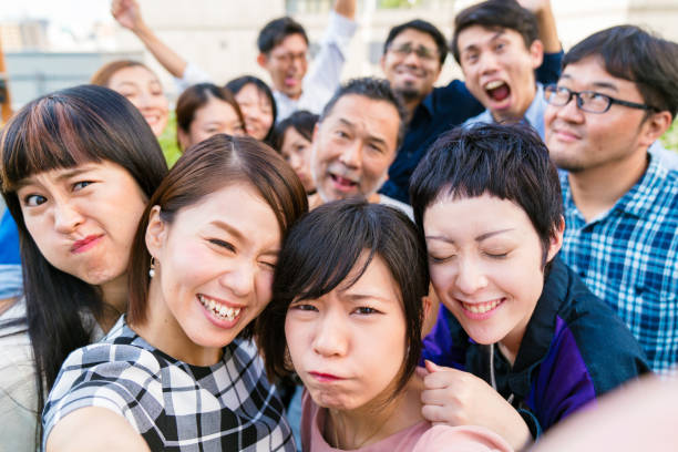 istock Group of friends at a rooftop party taking a selfie 856126688