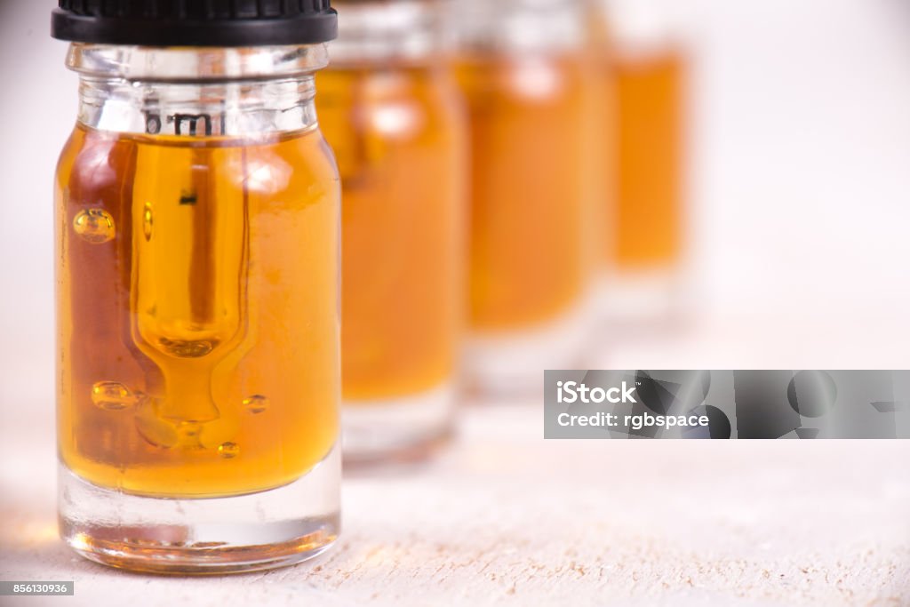 Vials of CBD oil, cannabis live resin extraction isolated on white - medical marijuana concept Macro detail of dropper with CBD oil, cannabis live resin extraction isolated on white - medical marijuana concept Cannabis Plant Stock Photo